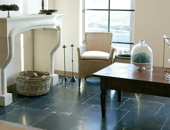 A renovated living room featuring a cozy fireplace and a stylish table, creating a warm and inviting atmosphere.