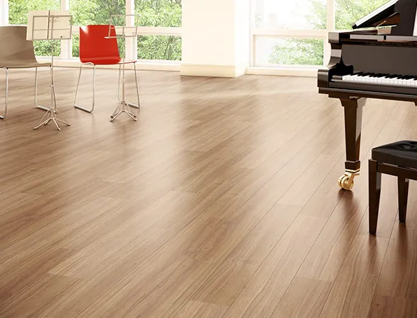 A renovated room featuring a piano and several chairs, creating an inviting atmosphere for music and gatherings.